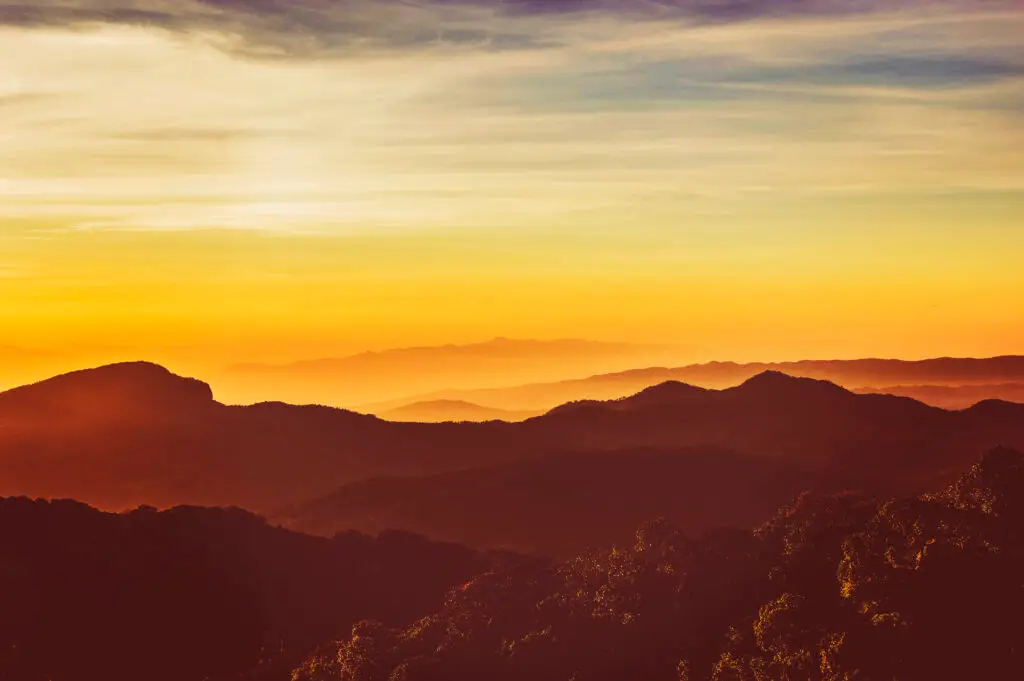 a sunset over mountains